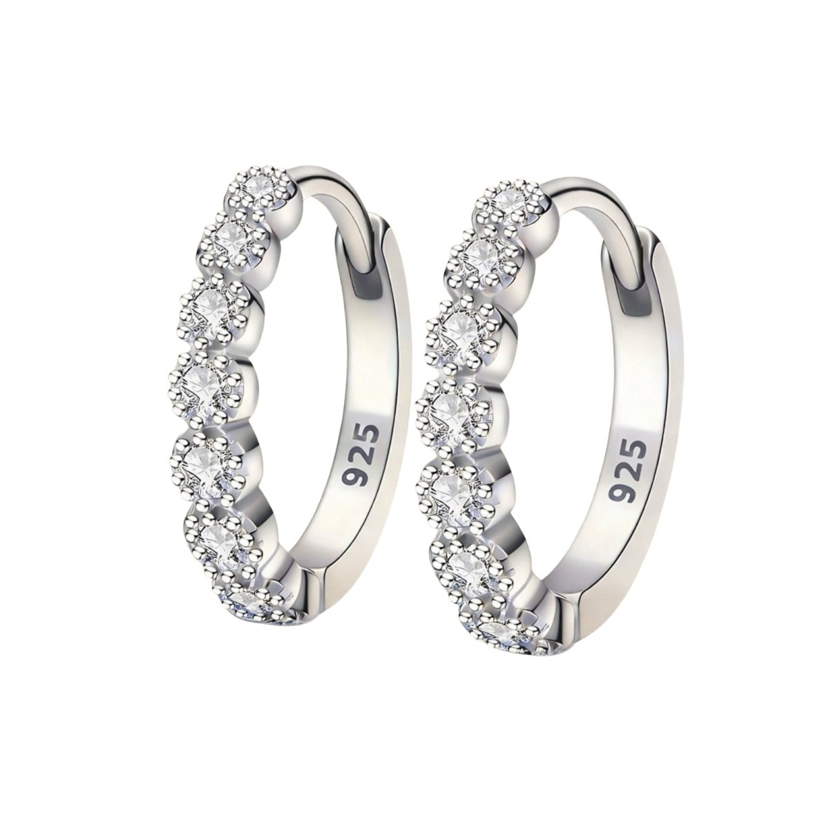 A detailed close-up of a pair of Kouvr 925 sterling silver huggie hoop earrings with sparkling pavé set diamond simulants on a white background.