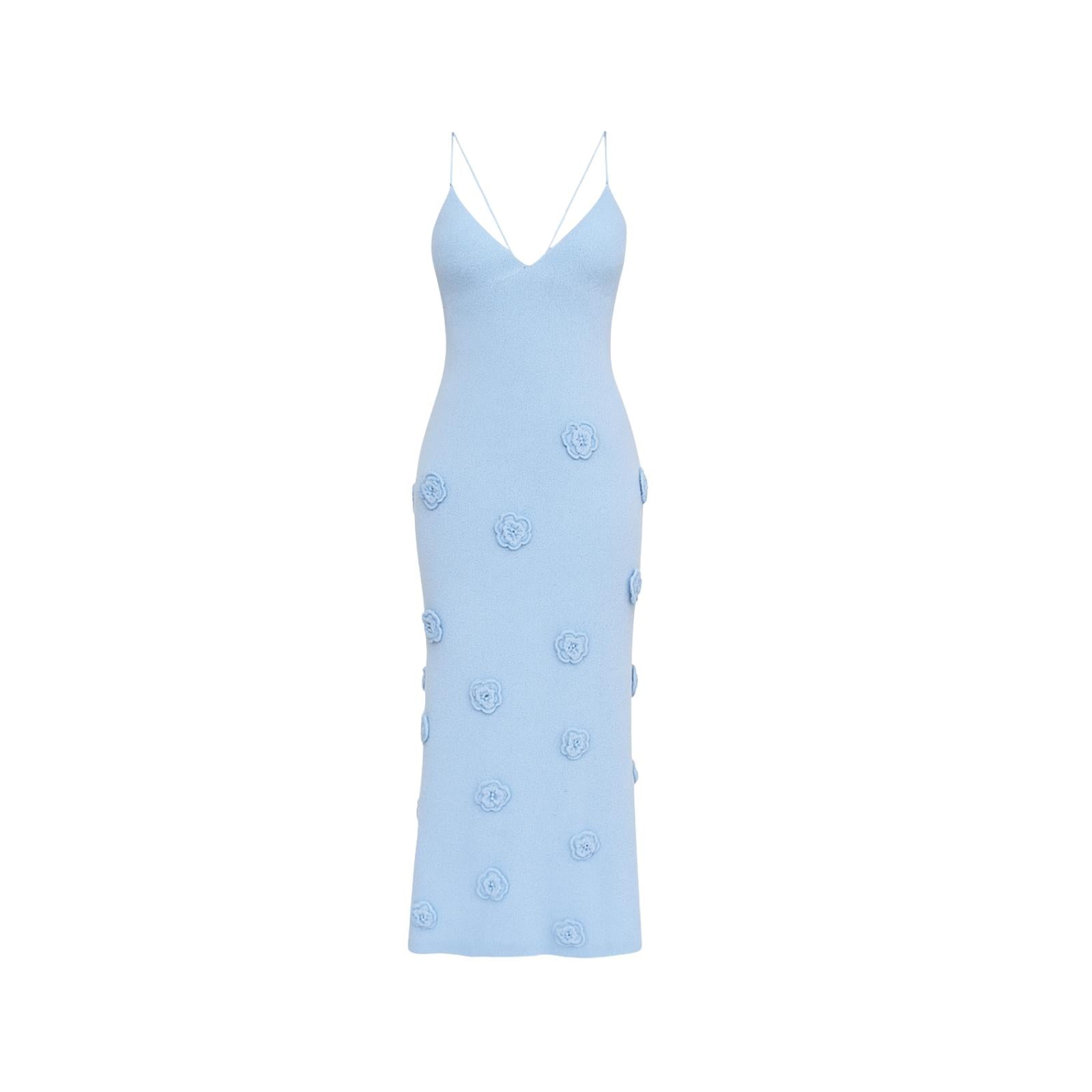 Model wearing the alexie sky blue knit maxi dress with 3D rosettes by Kouvr Fashion, front view.