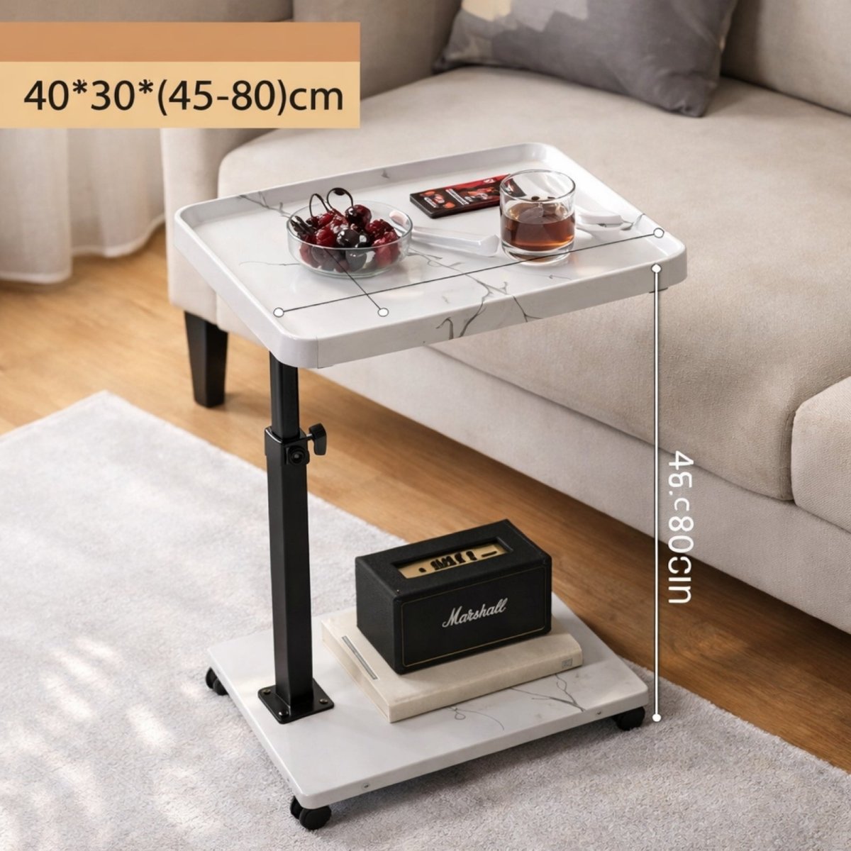 The Kouvr height-adjustable C-shaped side table in dark walnut, positioned over a beige sofa arm and styled with a coffee cup and bowl of raspberries