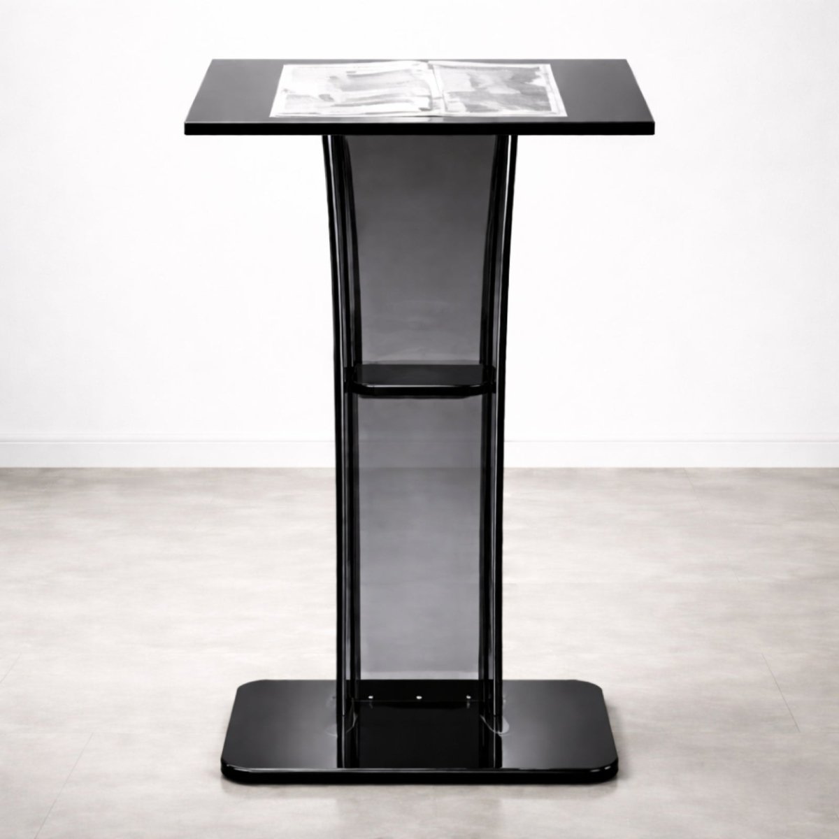 Front view of the Kouvr Aethel modern acrylic podium in a smoked black finish, shown in a minimalist white studio setting.