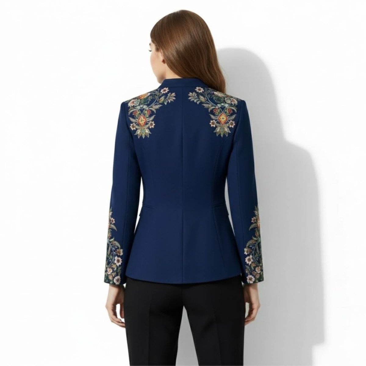 Back view of a model wearing the multicolor Kouvr Aiko military jacket, displaying the symmetrical floral embroidery on the upper back and shoulders.