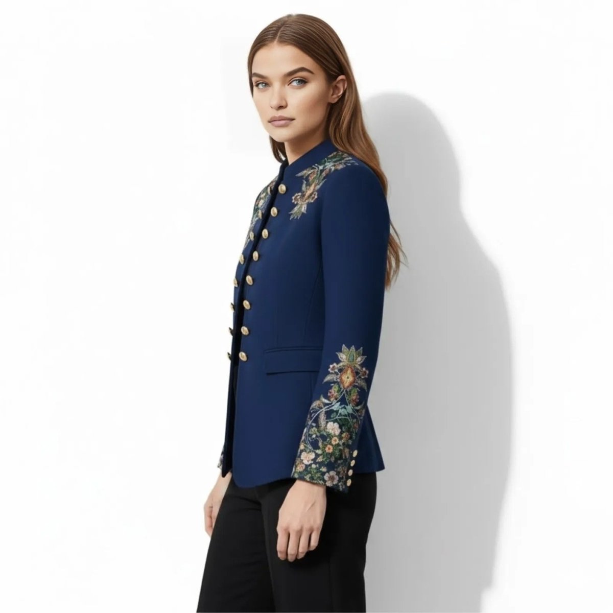 Model in a side profile wearing the multicolor Kouvr Aiko band jacket, highlighting the intricate floral embroidery on the sleeve cuff.