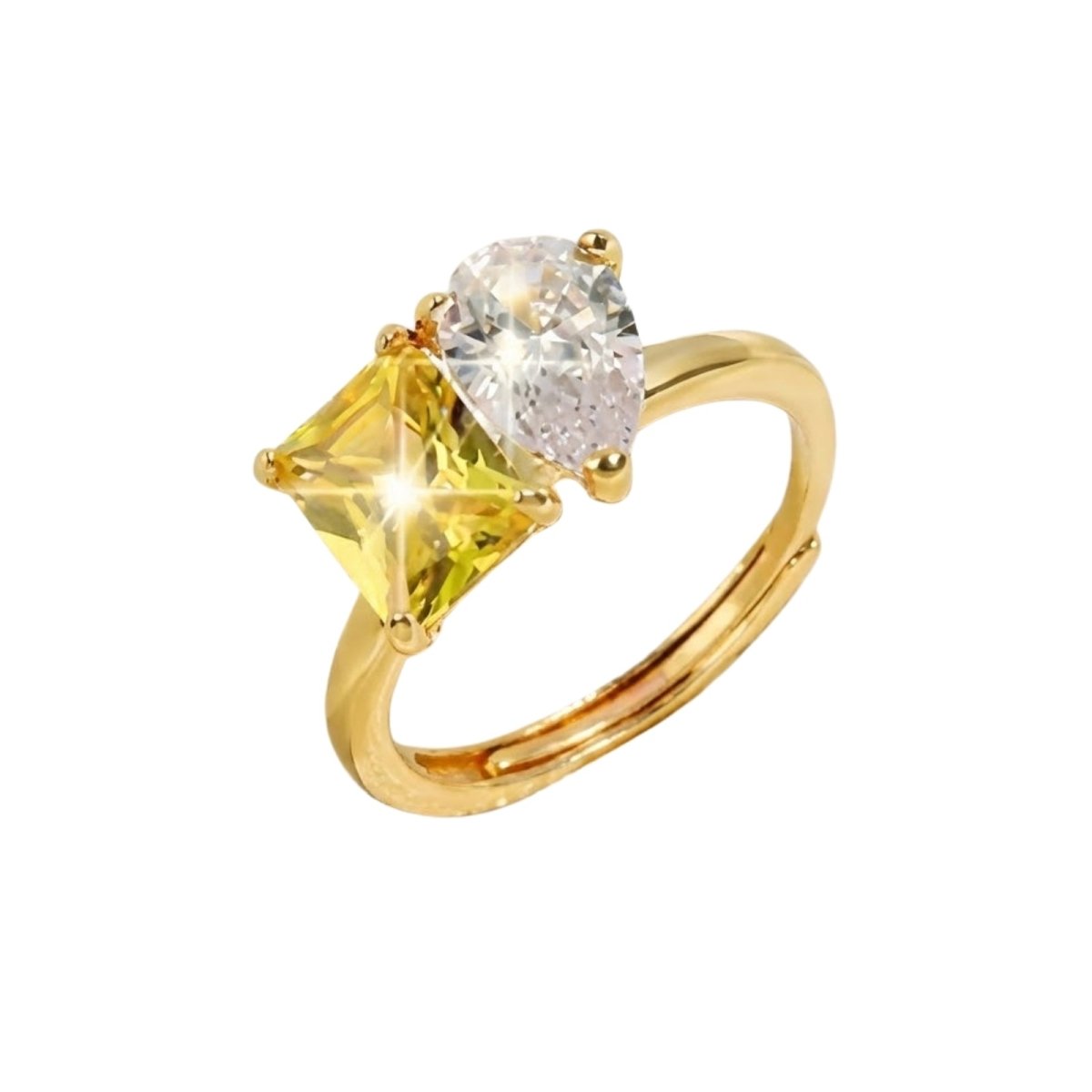 The Kouvr Alaia Toi et Moi Ring with a square princess-cut yellow stone and a clear pear-cut stone on an 18k gold plated adjustable band, shown on a white background.