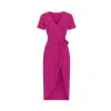 Woman walking in the Kouvr Aleia magenta and orange polka dot midi wrap dress with white sneakers