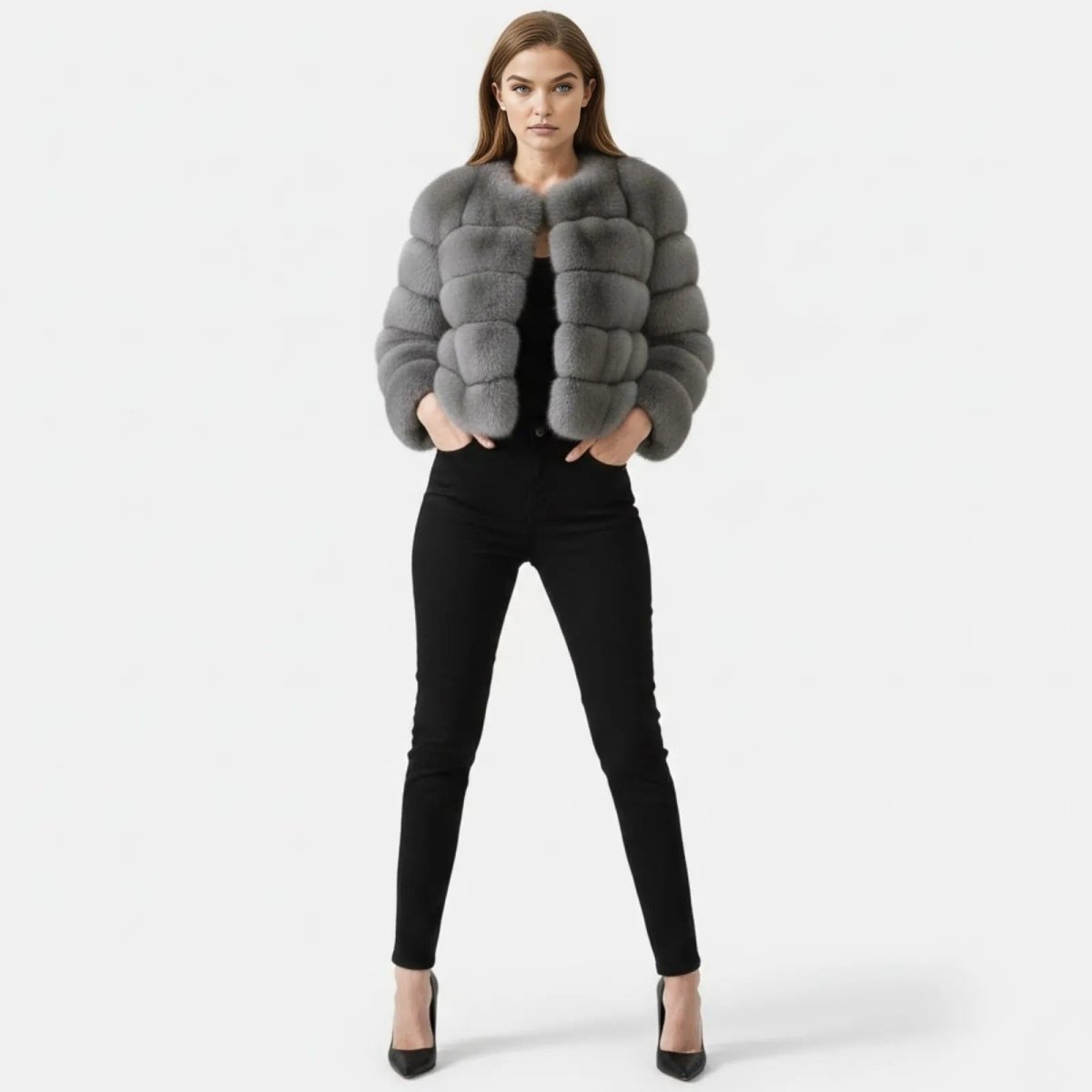 Model wearing the Alexia grey cropped faux fur jacket by Kouvr Fashion, shown from the front with hands in pockets.