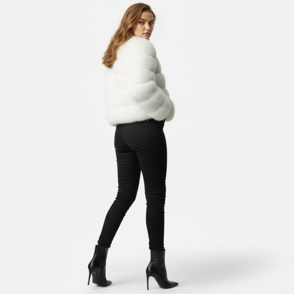Model looking over her shoulder showing the back view of the Kouvr Alexia white tiered faux fur jacket.