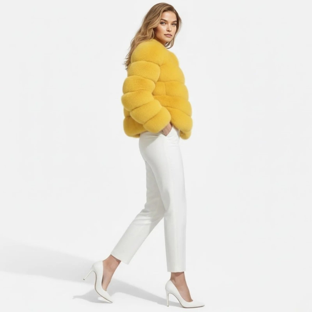 Model in a side profile walking pose wearing the short yellow faux fur jacket, showcasing its volume and texture.