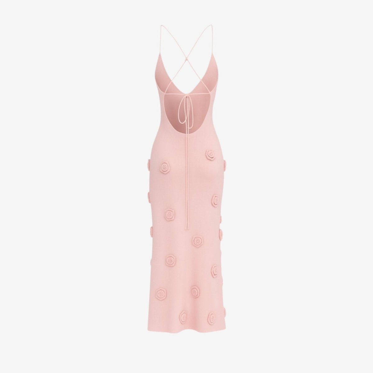 Pink slip dress with button details on a light gray background