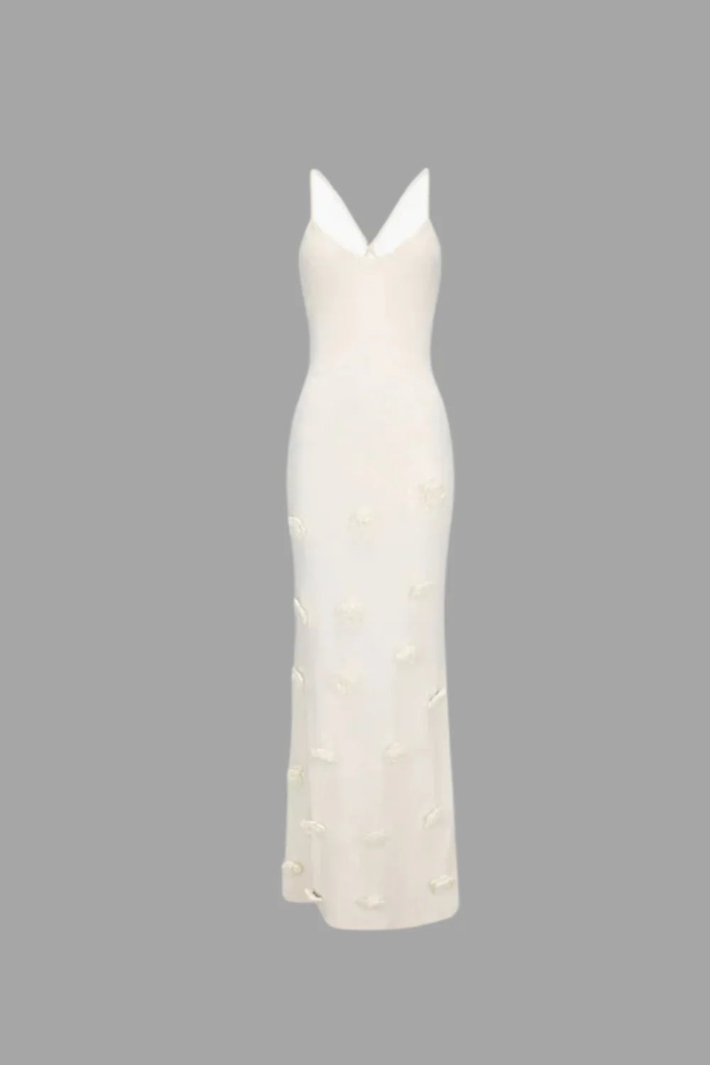 Model wearing the Kouvr Alexie backless white maxi dress with 3D floral details