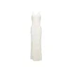 Model wearing the Kouvr Alexie backless white maxi dress with 3D floral details
