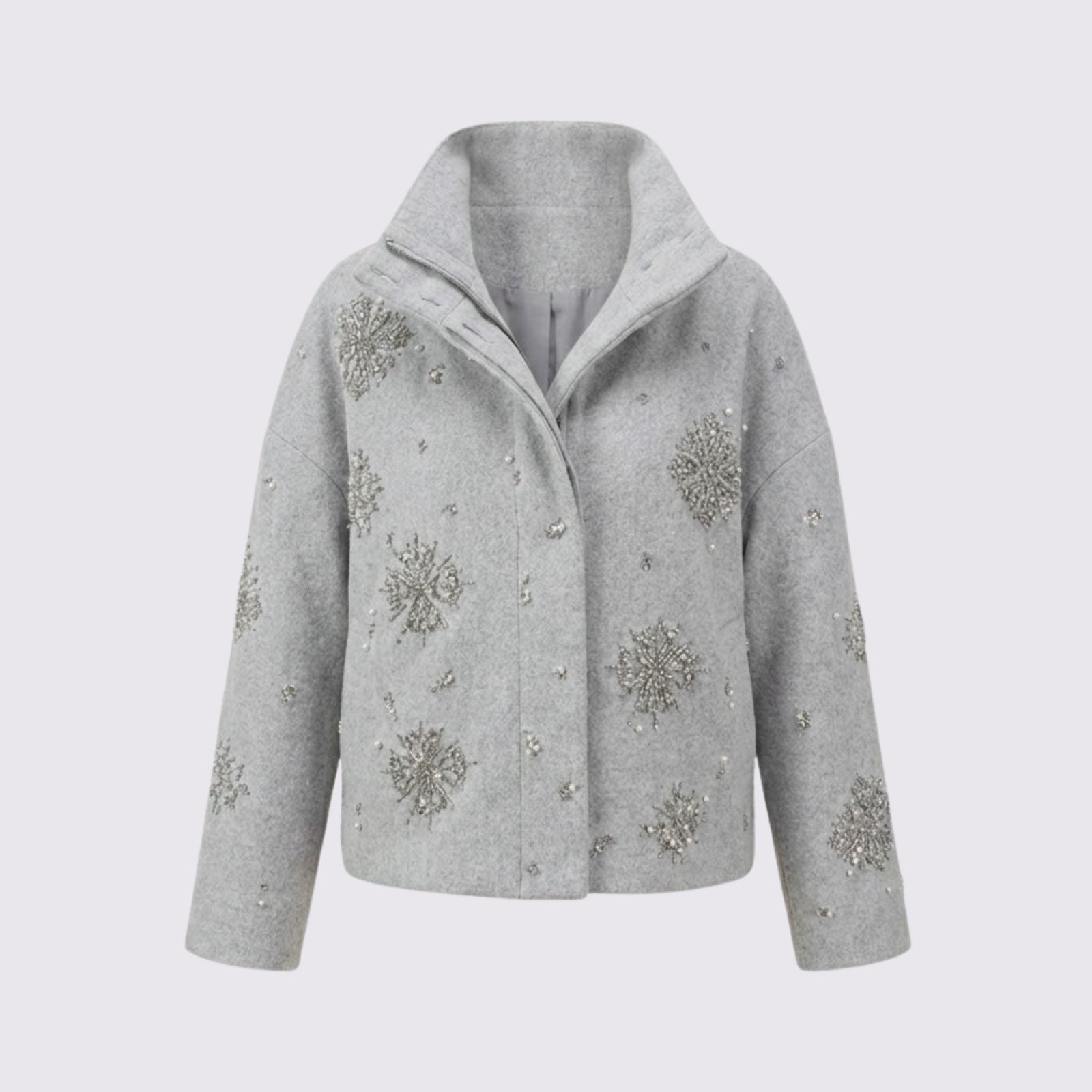 Front product shot of the Kouvr Alisa funnel neck jacket in light grey, laid flat to display the detailed silver and crystal snowflake embellishments on a light grey background.
