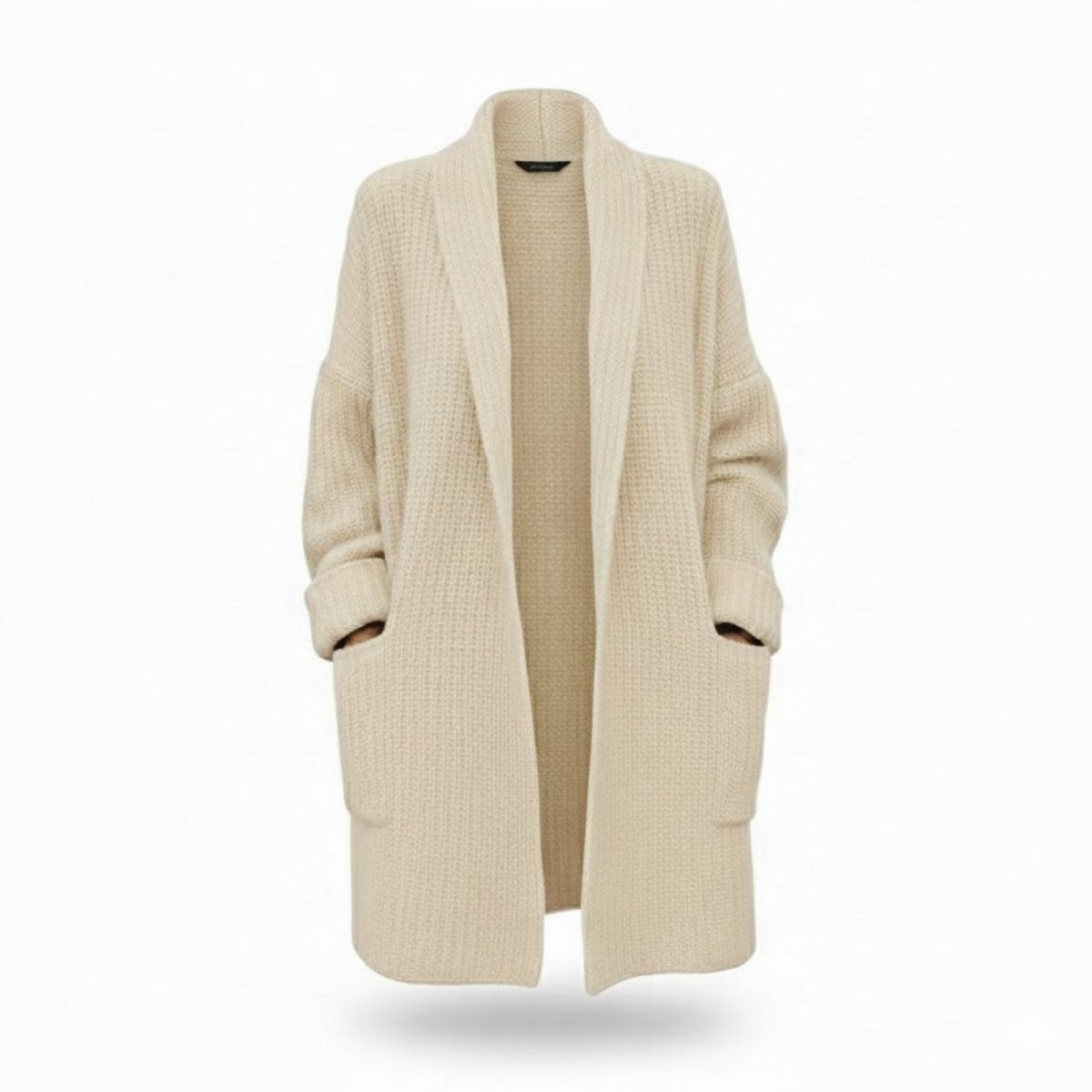 Studio product shot of the Kouvr Analyn open-front duster cardigan in ivory, highlighting the shawl collar and patch pockets.