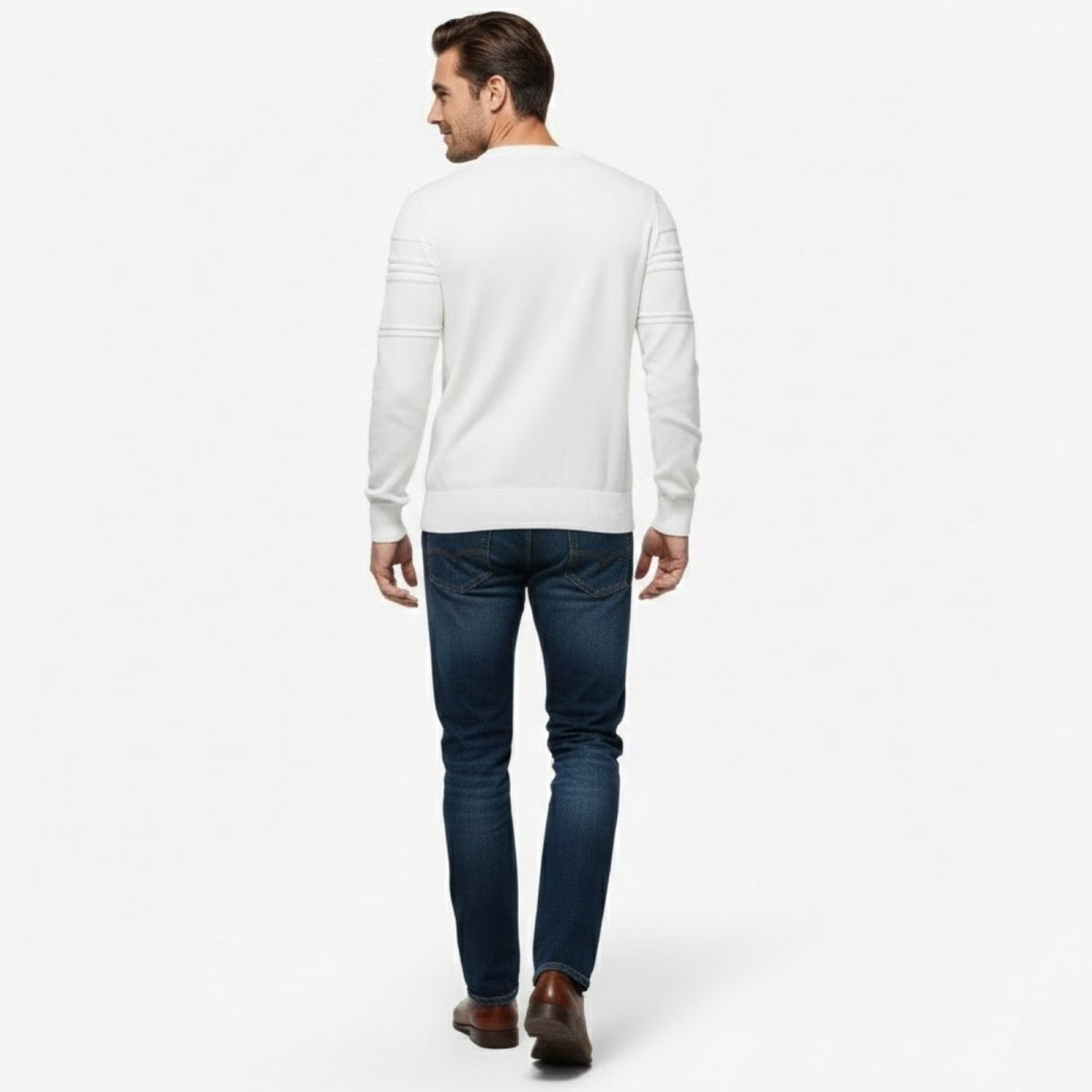 Back view of a man walking in a white Kouvr knit sweater, highlighting the clean design and structured sleeve panels.