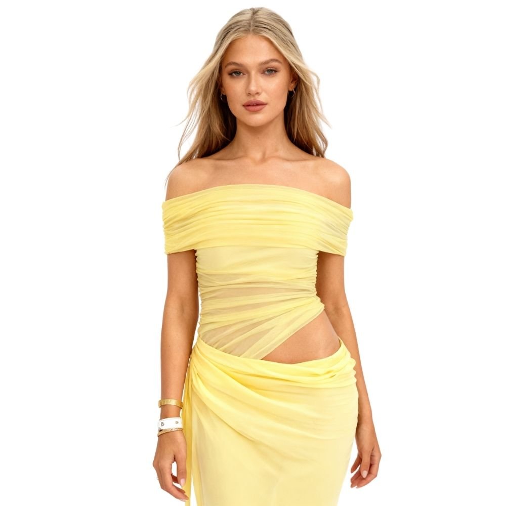 Model wearing the Kouvr Anita Gown in Lemon Chiffon, a yellow off-the-shoulder maxi dress with a side waist cutout
