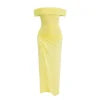 Model wearing the Kouvr Anita Gown in Lemon Chiffon, a yellow off-the-shoulder maxi dress with a side waist cutout