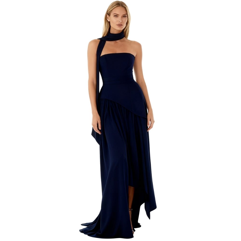 Navy Kouvr evening gown with a high slit on a white background