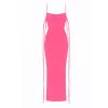 Model wearing the Kouvr Ari backless maxi dress in electric pink, standing with hands on hips