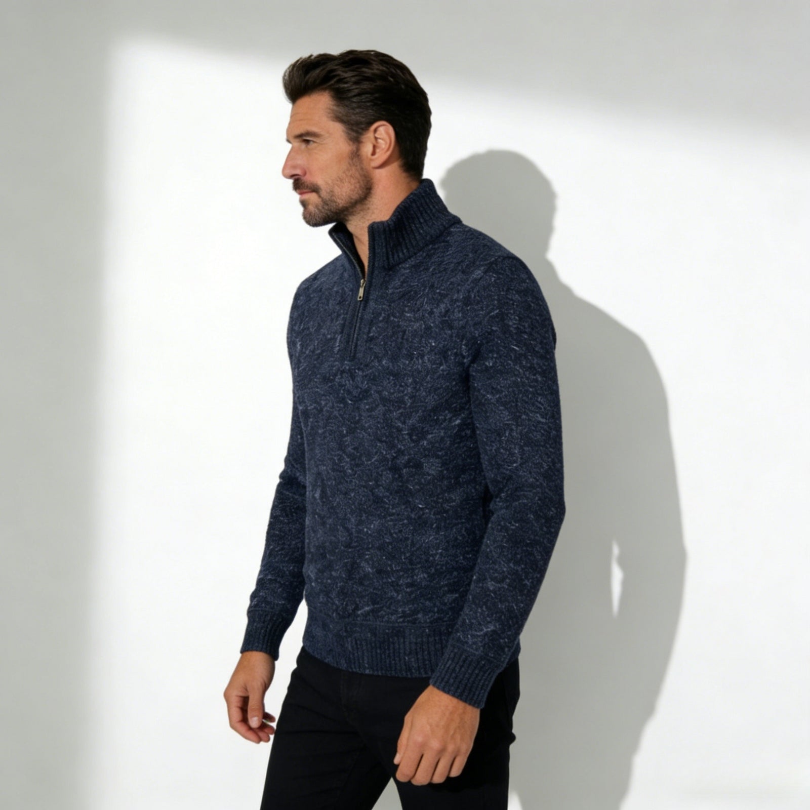 Man wearing the Kouvr Elyson men's textured quarter-zip sweater in a deep navy marl, styled with black trousers.