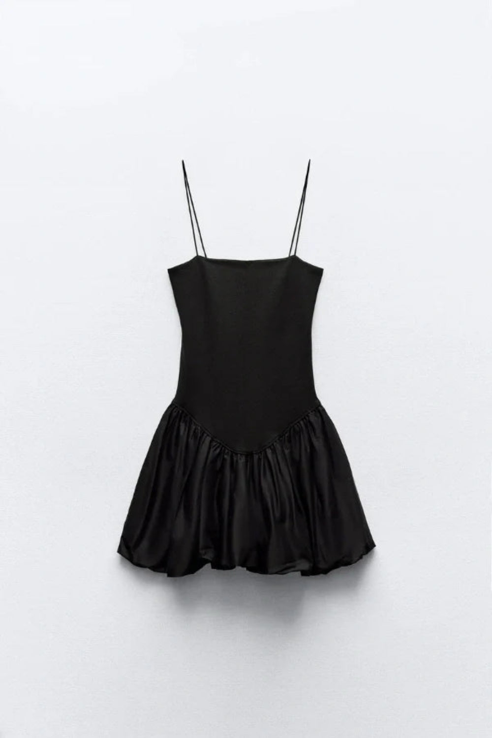 Model wearing the Kouvr Aubrey black mini dress with a voluminous bubble skirt and square neckline