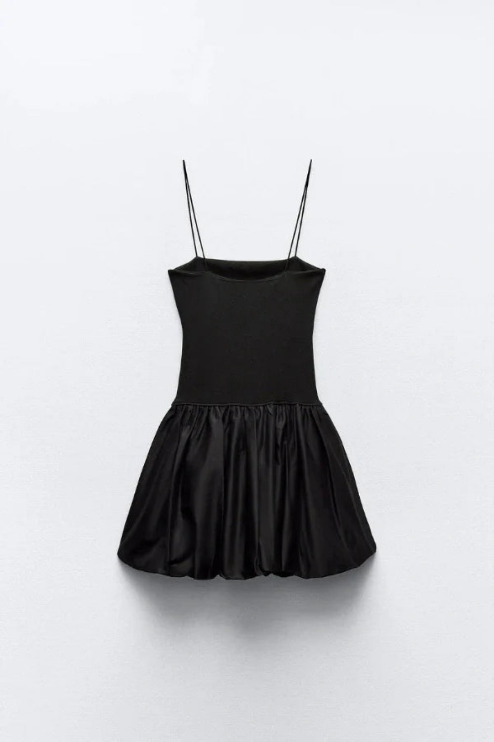 Model wearing the Kouvr Aubrey black mini dress with a voluminous bubble skirt and square neckline
