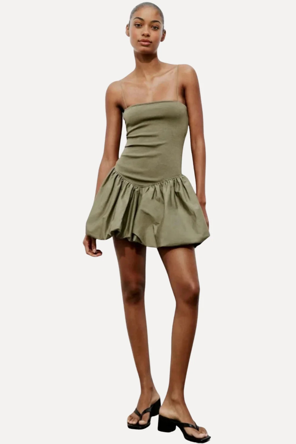 Model from the back wearing the Kouvr Aubrey olive green drop waist mini dress with a sculptural bubble skirt