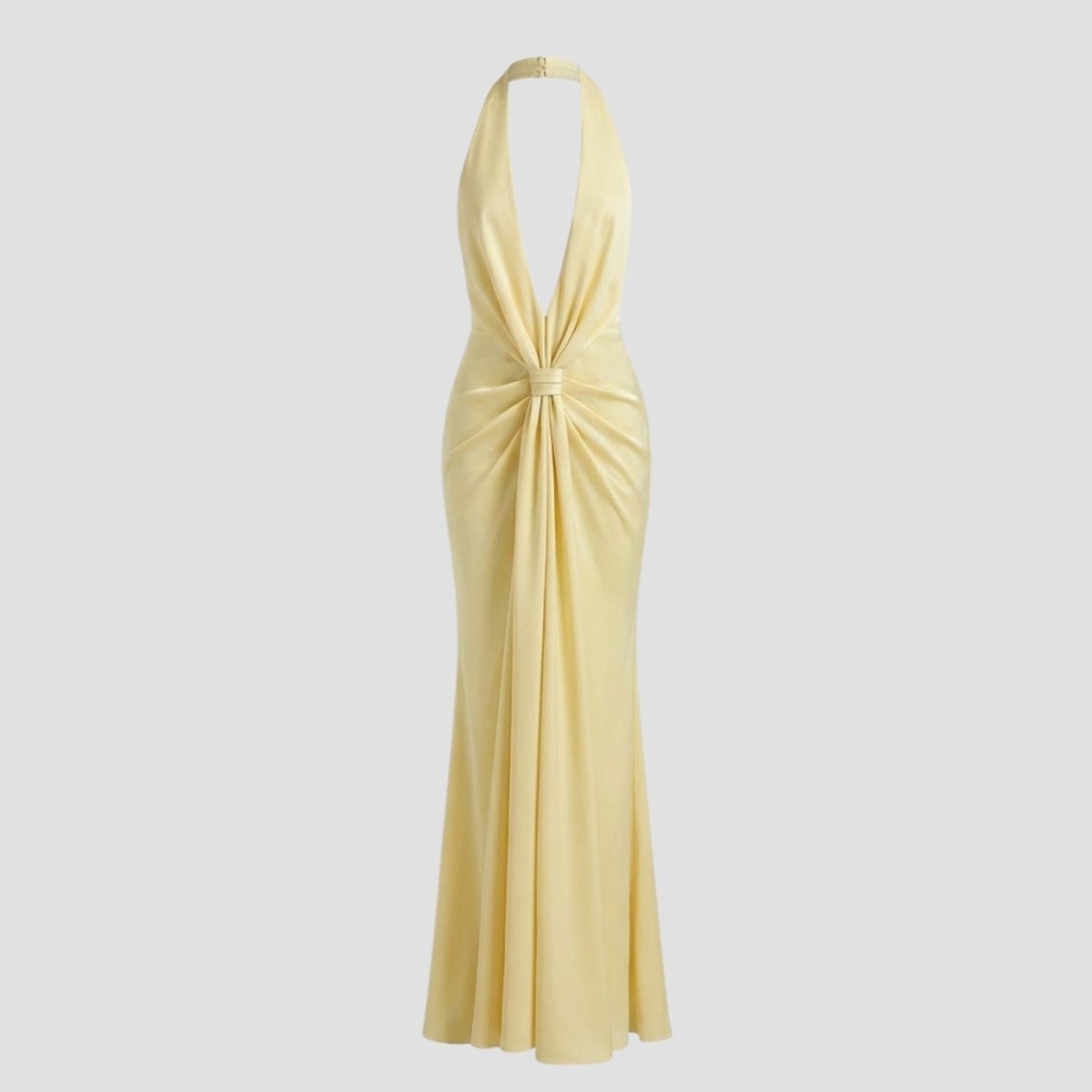 Flat lay of the Kouvr Beverly halter gown in light yellow, showcasing the elegant twist knot front and plush velvet fabric.