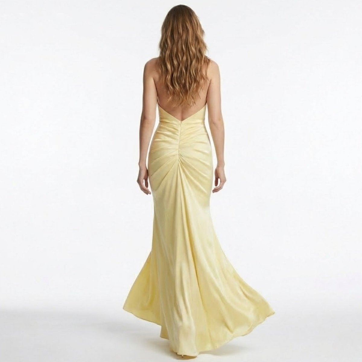 Back view of the Kouvr Beverly light yellow formal dress highlighting the completely open back and flattering ruched detailing.