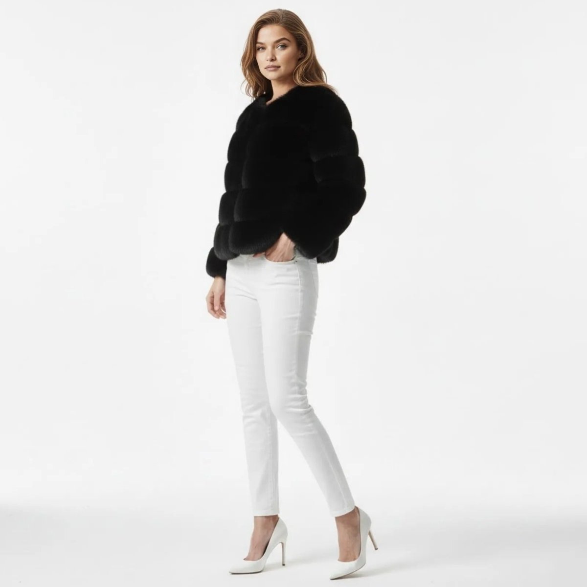 Model in a side profile view wearing the Kouvr black panelled faux fur jacket.