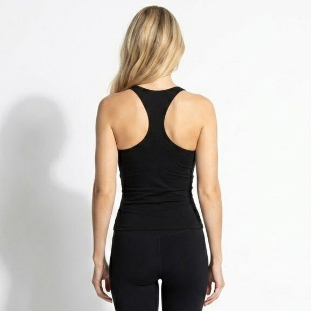 Back view of Kouvr premium black Y-back camisole showing delicate spaghetti straps and seamless stretch fit