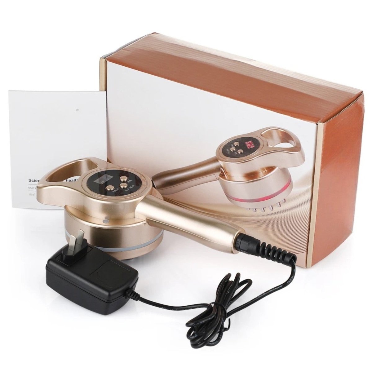 The complete Kouvr body sculpting massager kit, including the gold-tone device, power adapter, and instruction manual in front of its box.