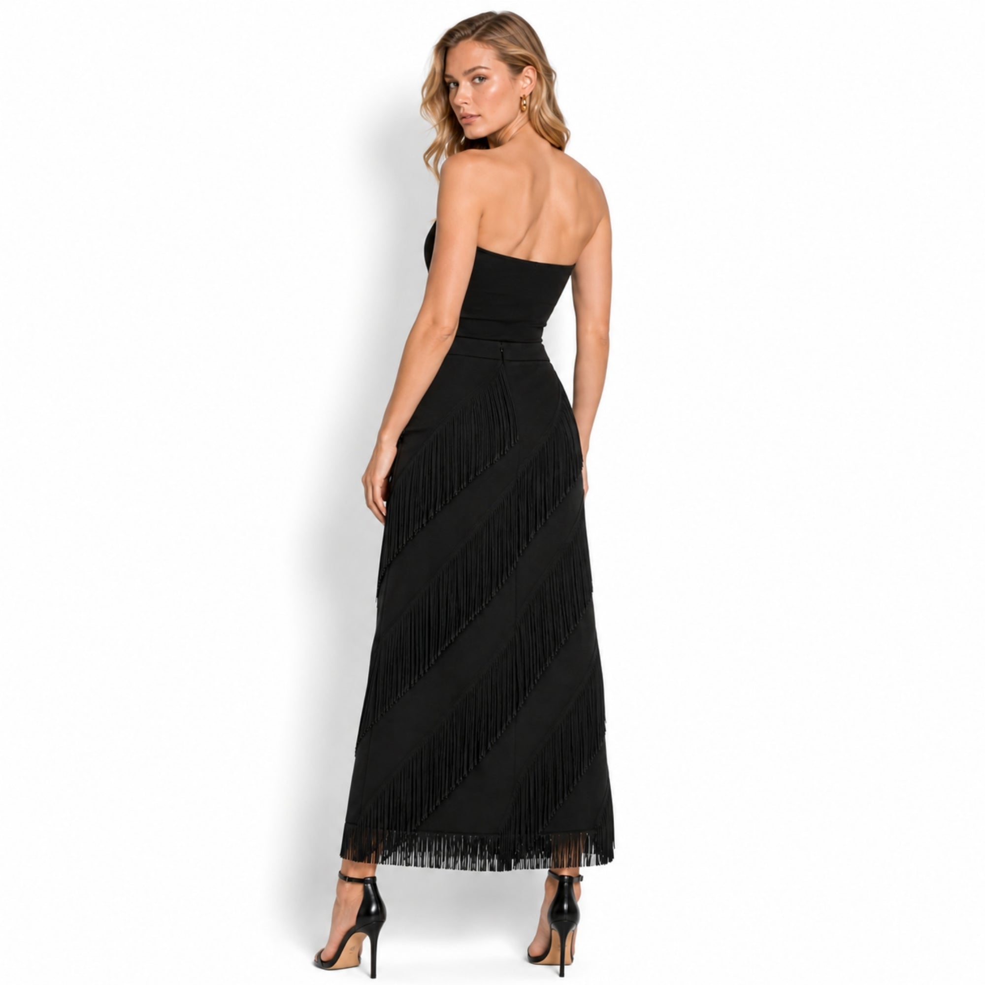Back view of women's black fringed long skirt showcasing the tailored high-waisted fit and concealed back zipper