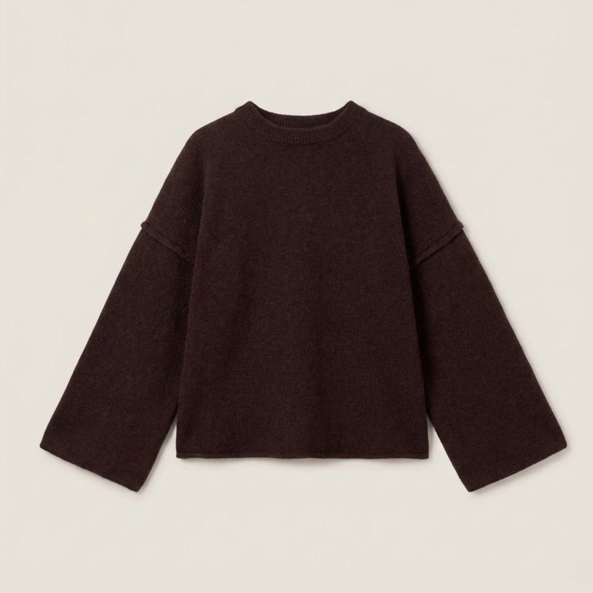 Flat lay of the Kouvr oversized dark brown sweater showcasing its wide sleeves and crewneck.