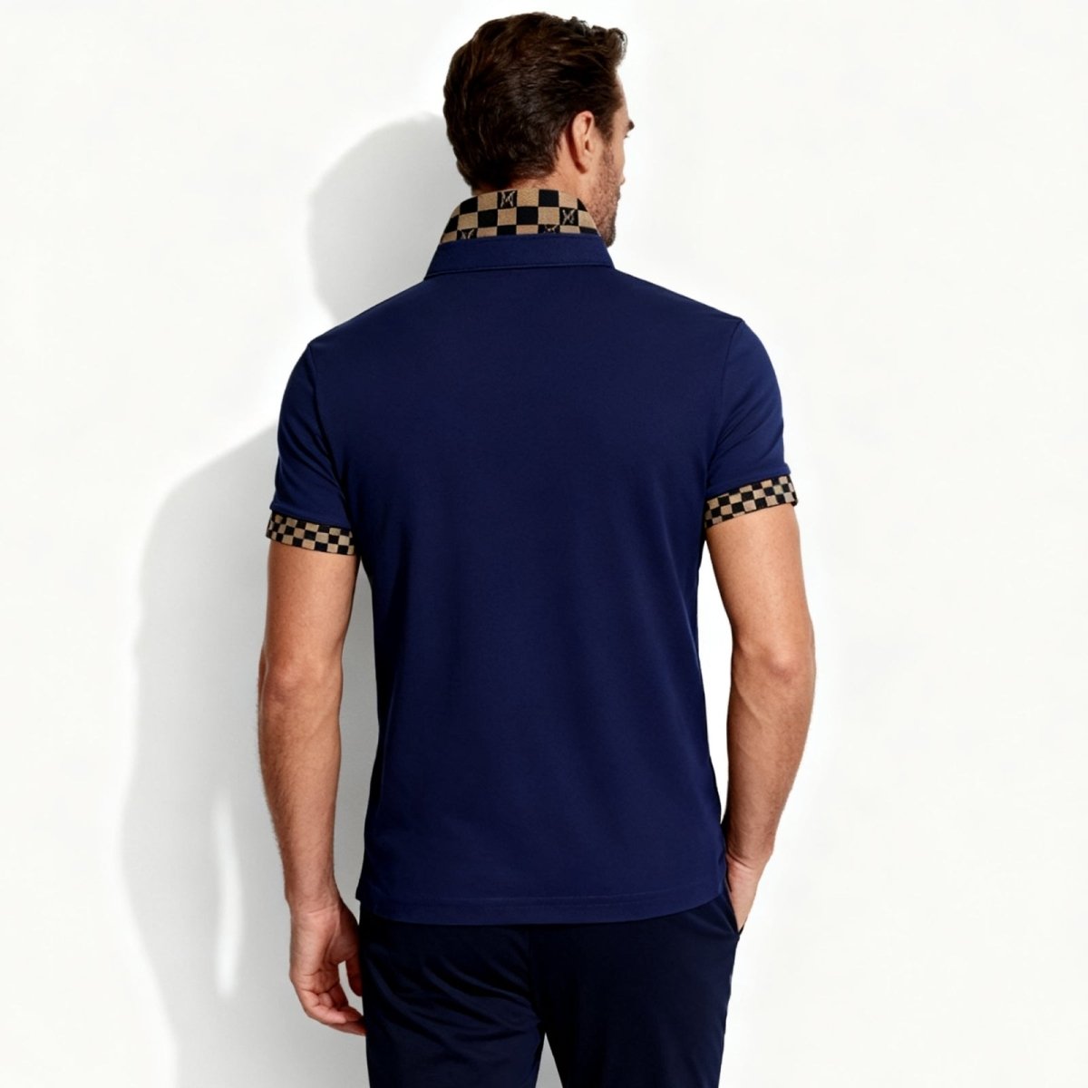 Back view of the Kouvr Brent polo shirt in navy, showing the clean lines of the tailored fit and the sophisticated checkered collar design.