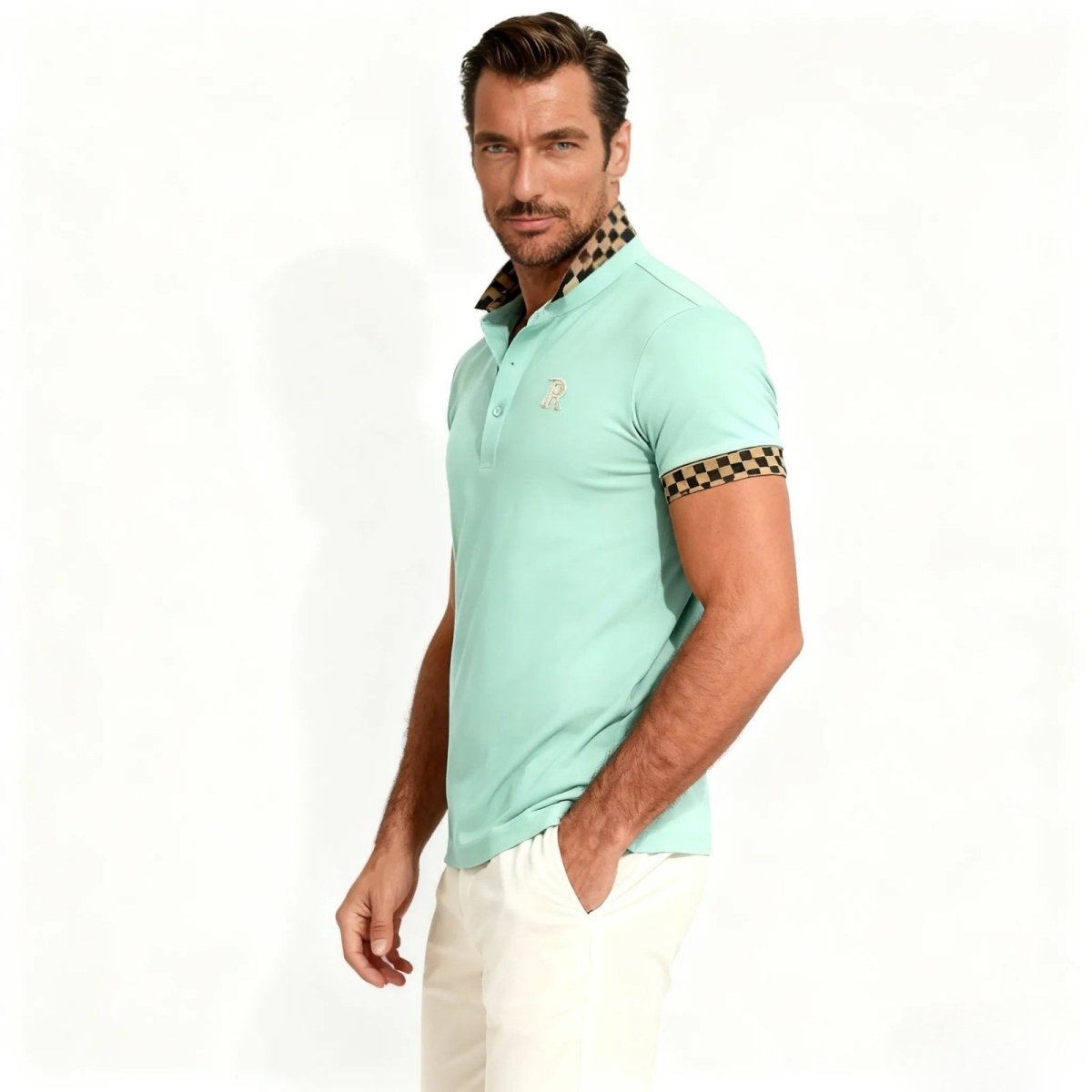 Side view of a model in the Kouvr Fashion Brent luxury mint green polo, highlighting the athletic fit and checkerboard sleeve cuff detail.