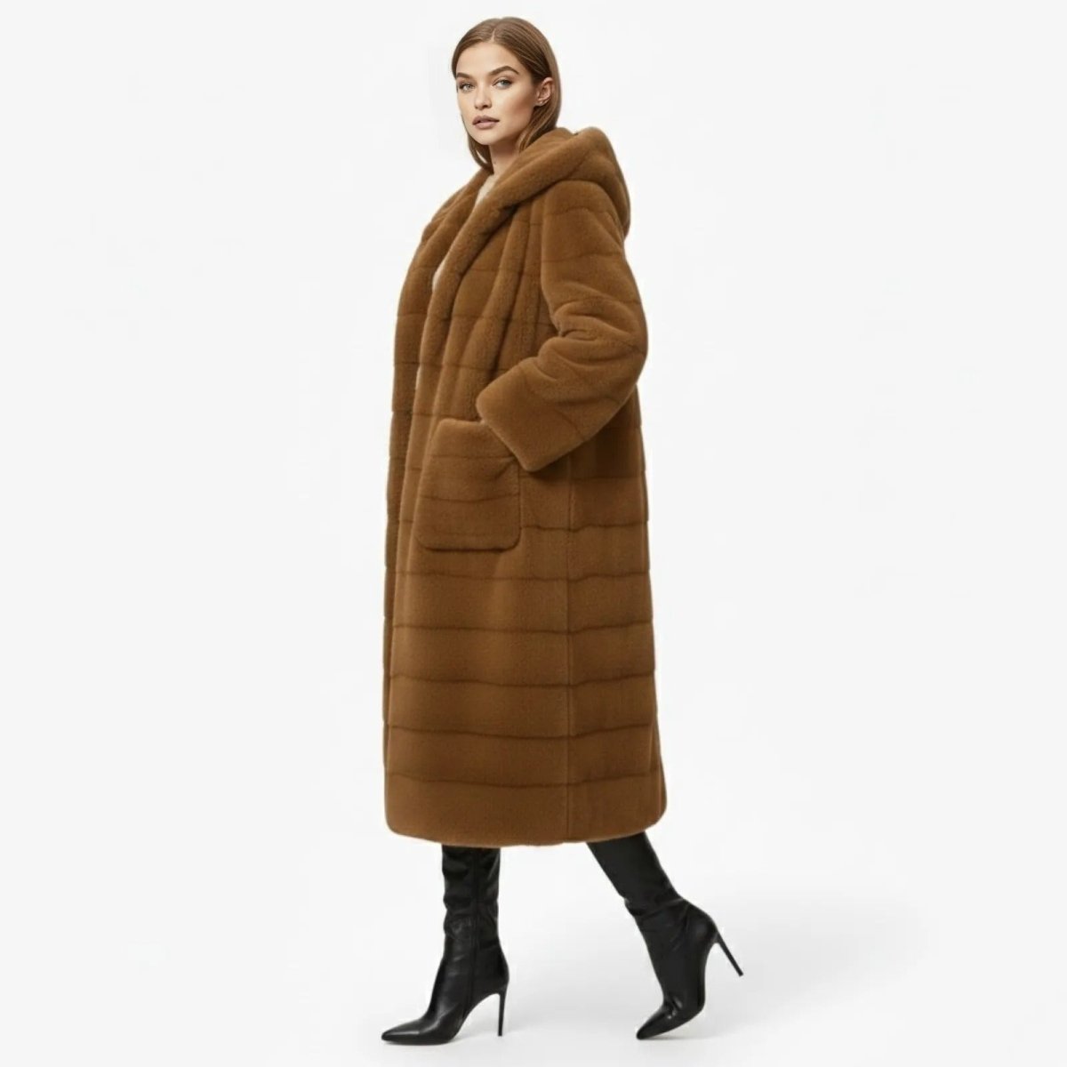 Side profile of a woman wearing a camel oversized hooded faux fur winter coat showing its length and patch pocket detail. 