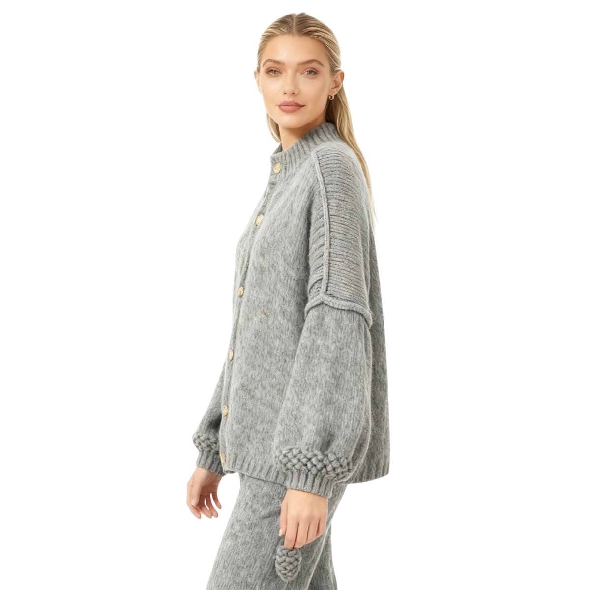 Woman wearing a gray Kouvr knit cardigan on a white background