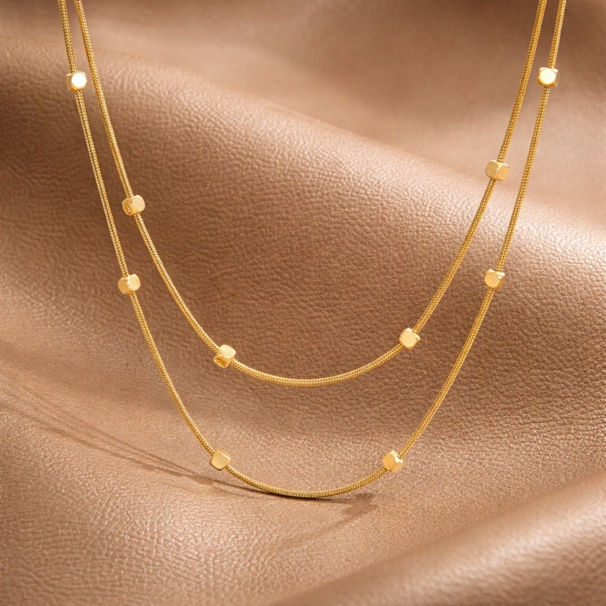 Infographic showing the Kouvr double layer gold necklace with dimensions like 42cm length, 3mm bead size, and features like 304 stainless steel and handmade quality.