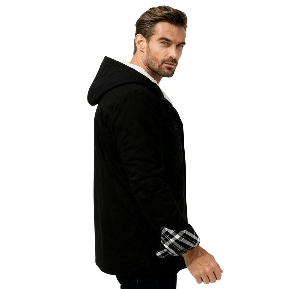 Man wearing a black kouvr hooded jacket with plaid cuffs on a white background
