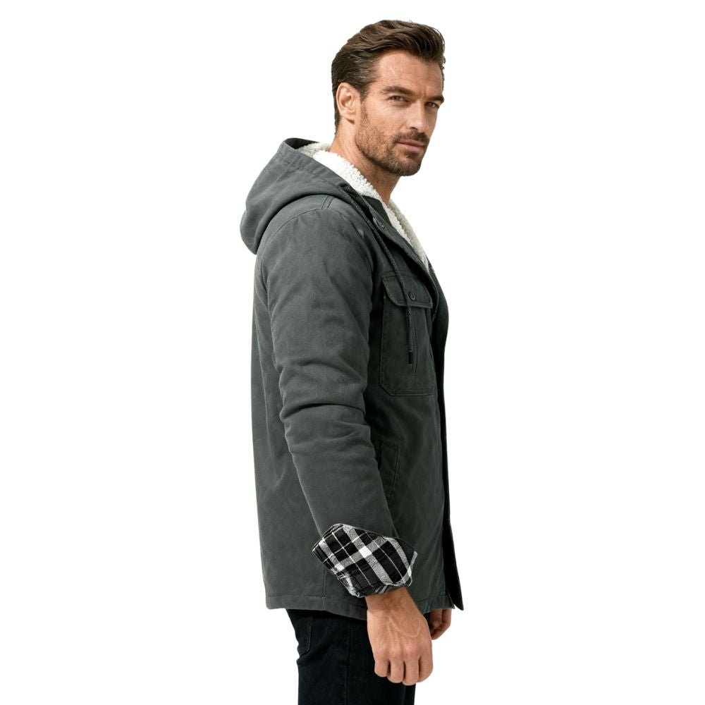 Man wearing a grey kouvr jacket with plaid cuffs on a white background