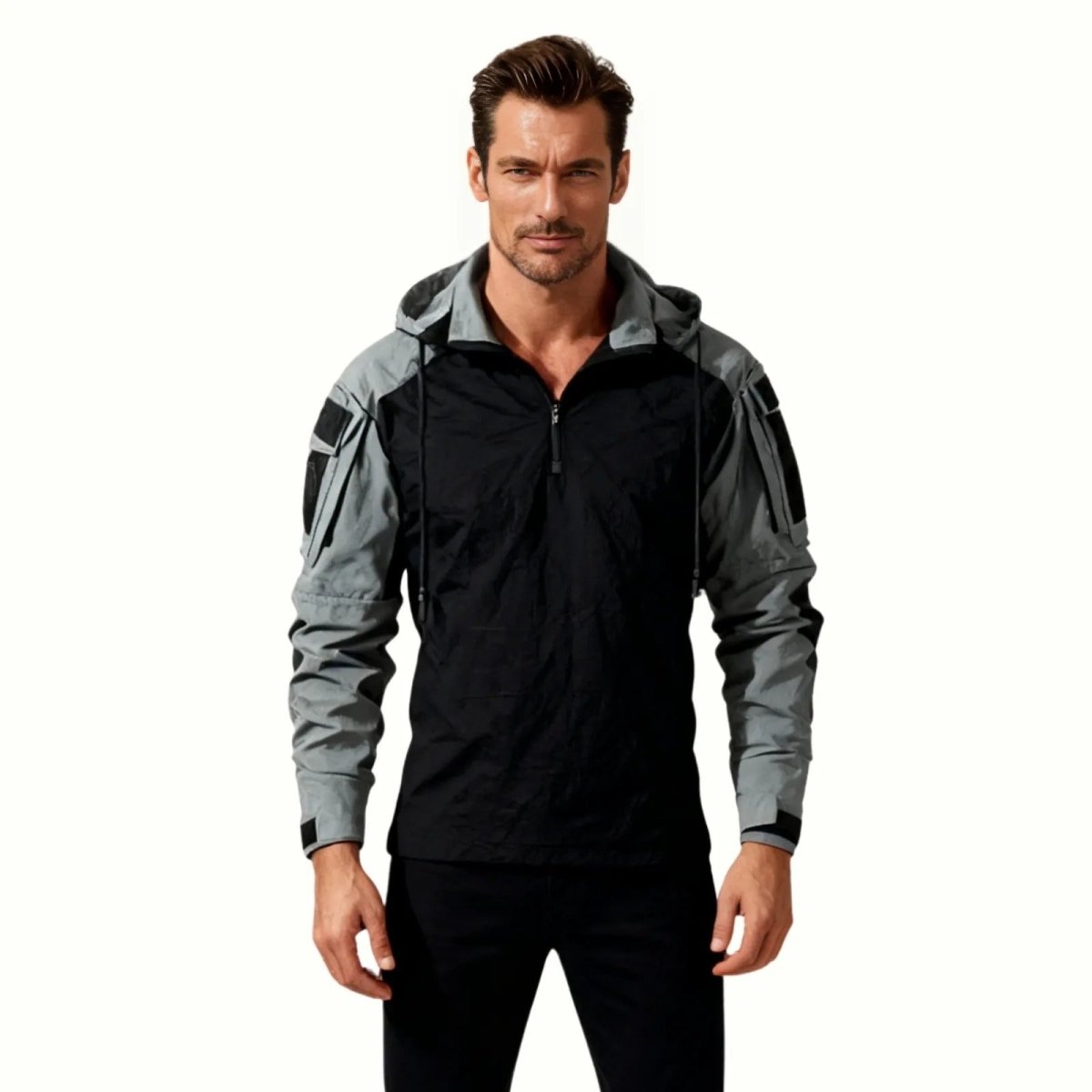 Male model wearing the Kouvr Clint Tactical Anorak Jacket in grey, showing the front view and half-zip detail.