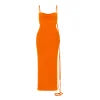 Model wearing Kouvr Fashion's Sunset Orange backless maxi dress with a cowl neck and lace-up back detail
