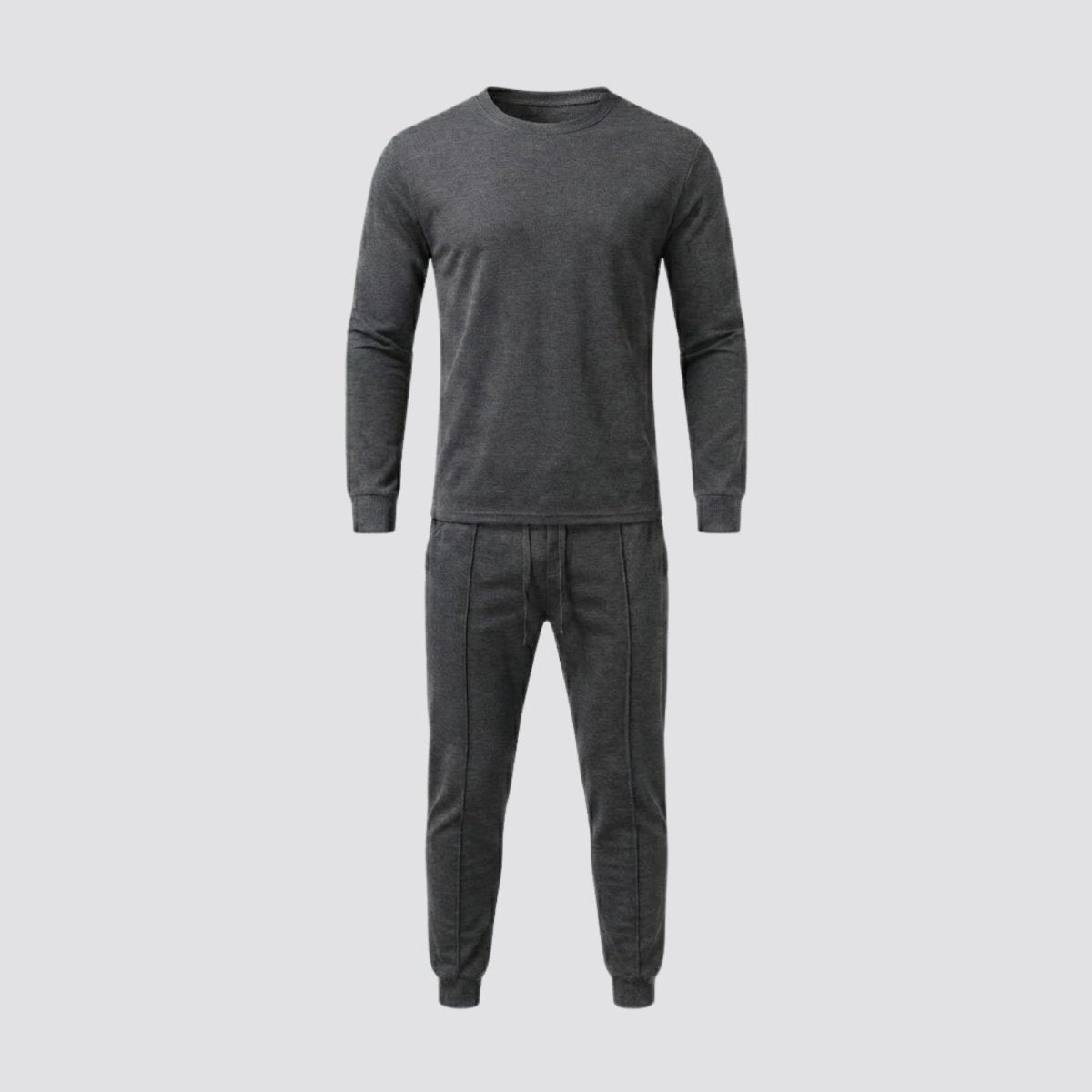 Front view flat lay of the Kouvr Crue dark grey crewneck top and matching jogger pants against a light grey background.
