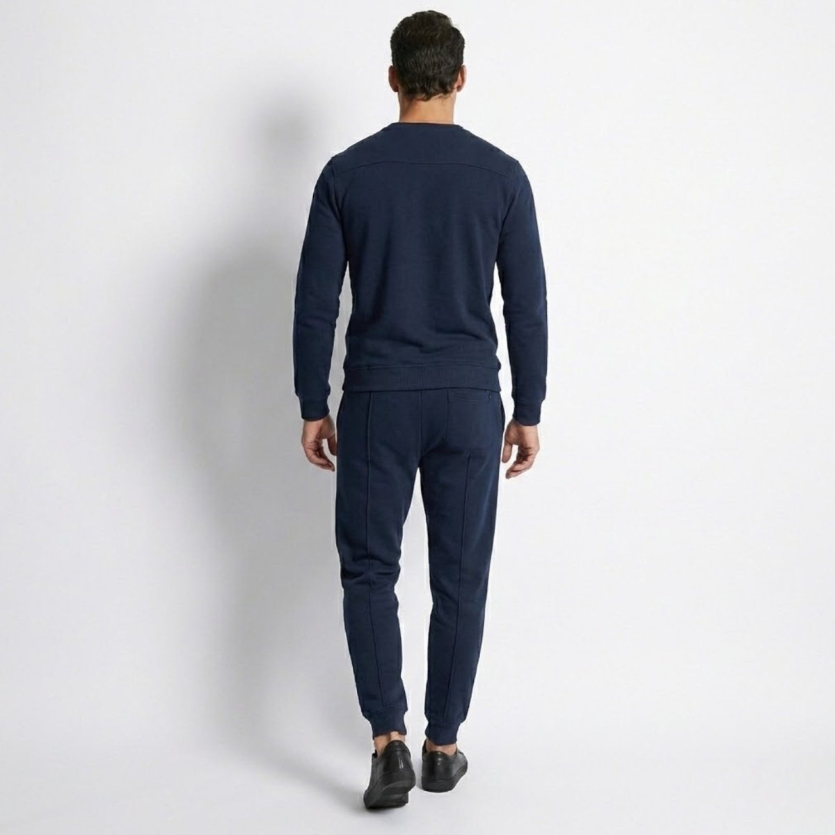 Back view of the Kouvr Crue navy lounge set, highlighting the clean lines and shoulder panel detail on the sweatshirt.