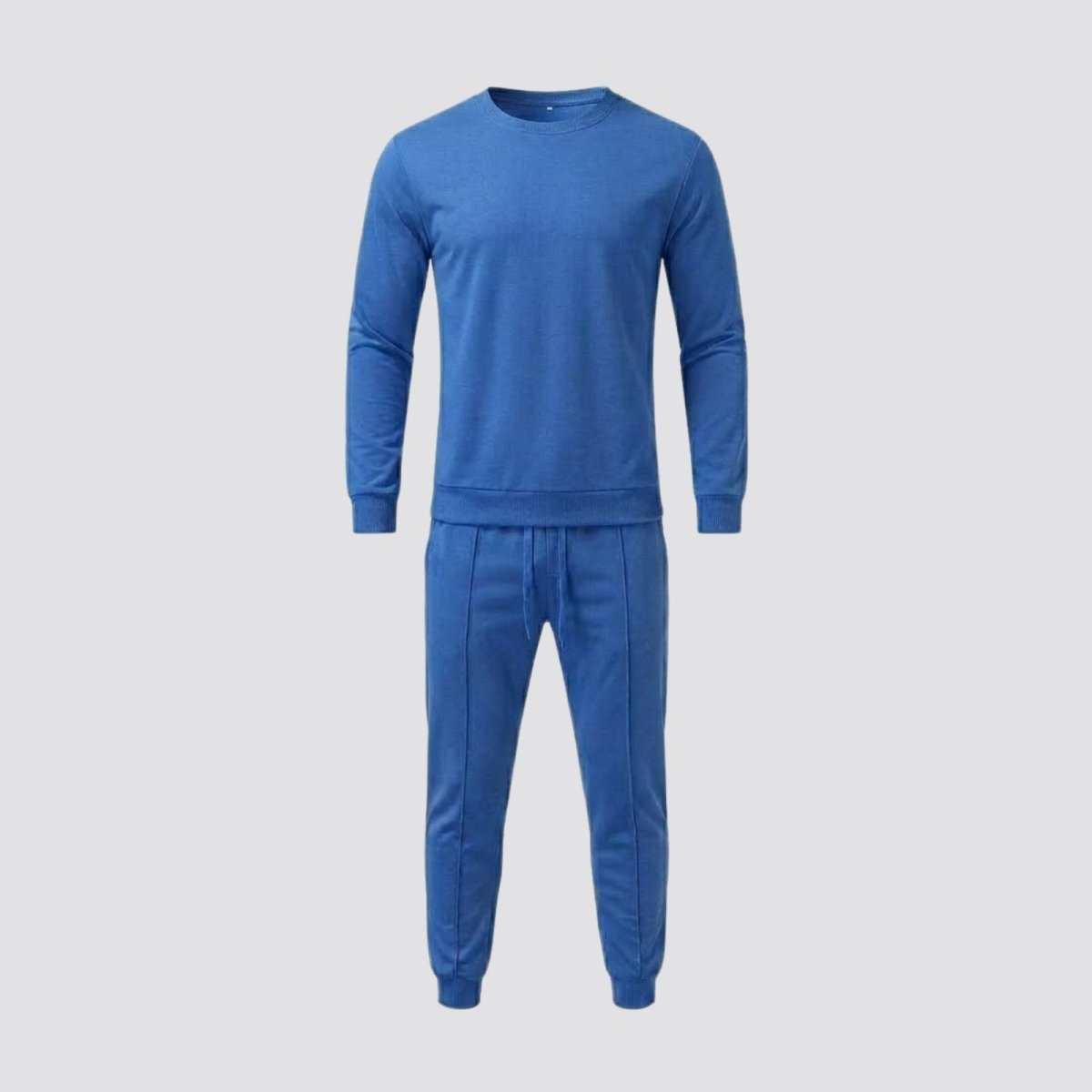 Front view of the two-piece Kouvr men's Crue tracksuit in blue, laid flat to show the crewneck top and drawstring joggers.