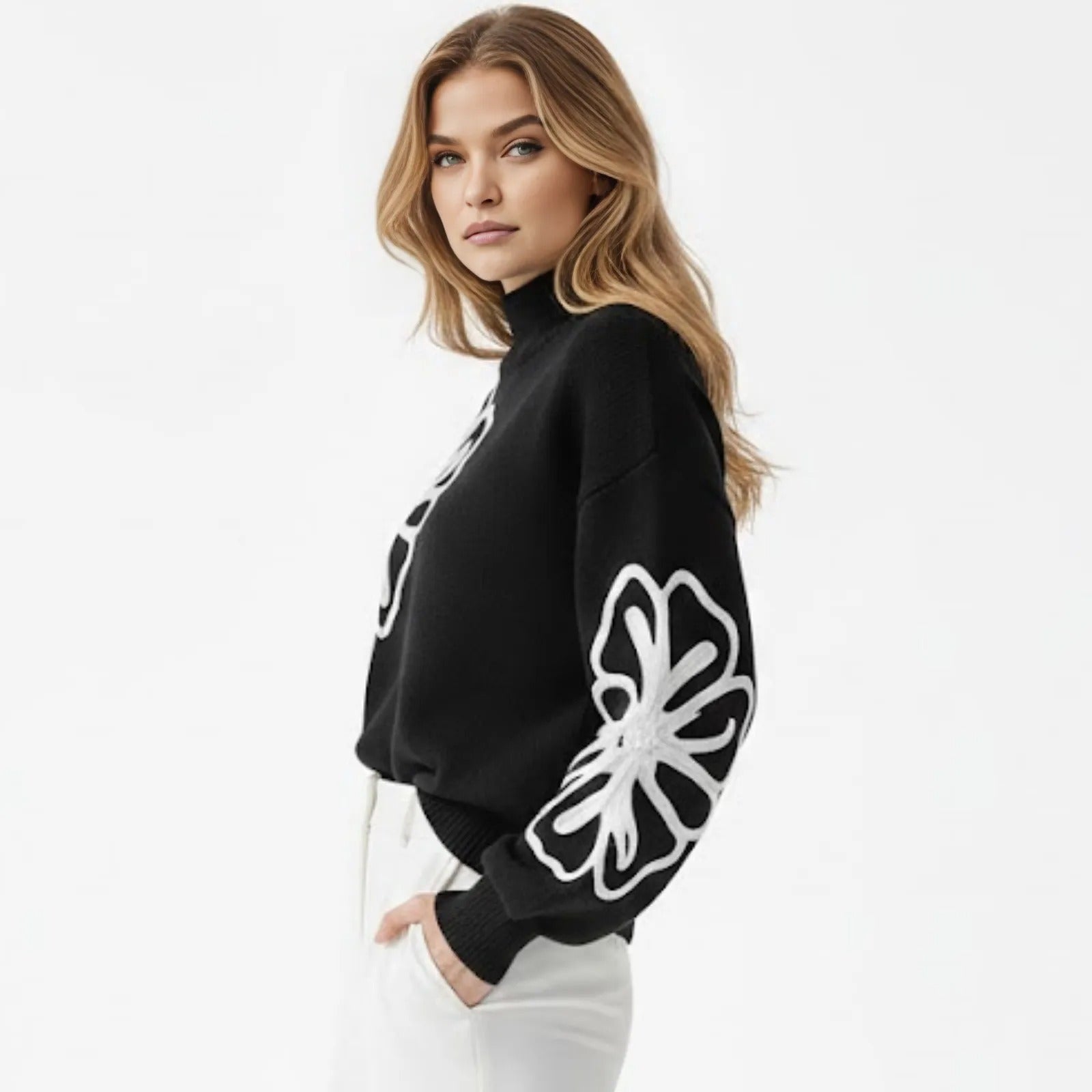 Side profile of a model wearing the Kouvr Cynthia sweater, highlighting the intricate white floral embroidery on the voluminous balloon sleeve.