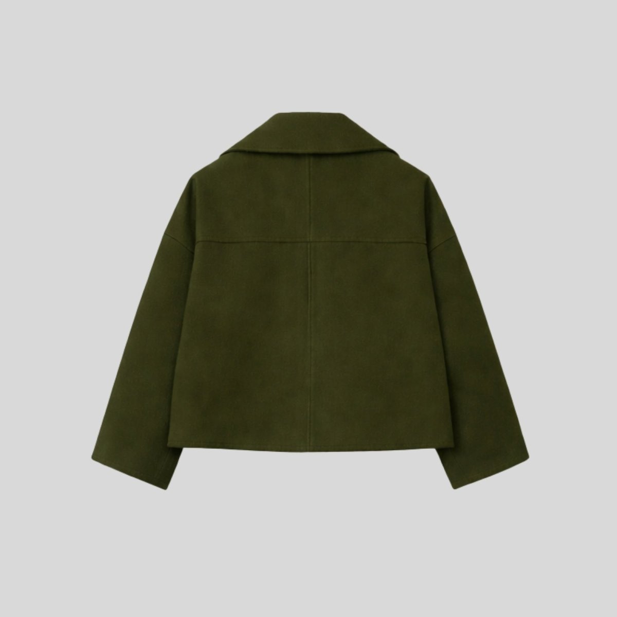 Product-only studio shot of the back of the Kouvr cropped wool peacoat in dark green, displaying the shoulder yoke and construction.