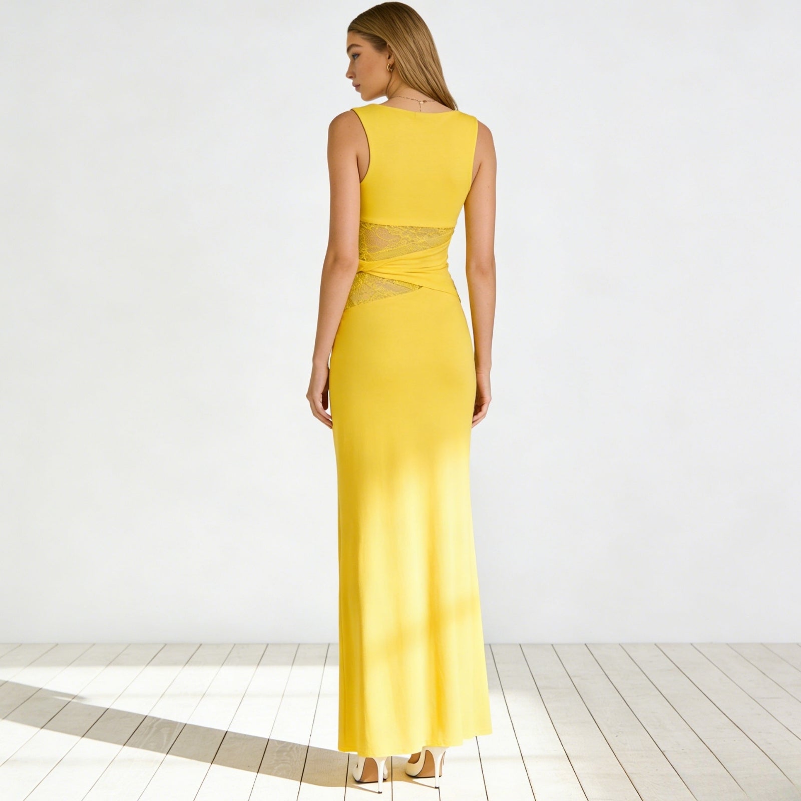 Back view of the Kouvr Fashion sleeveless yellow midi dress, showcasing the high back and form-fitting silhouette.