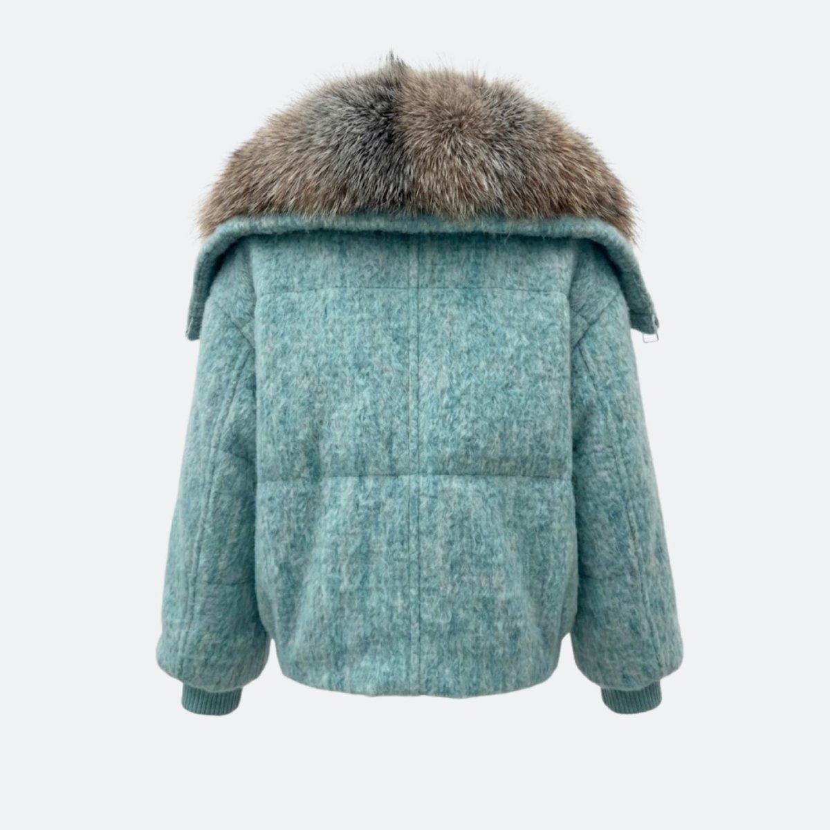 Flat lay back view of the Kouvr Dorothy jacket, detailing the heathered blue wool-blend fabric and panel construction.