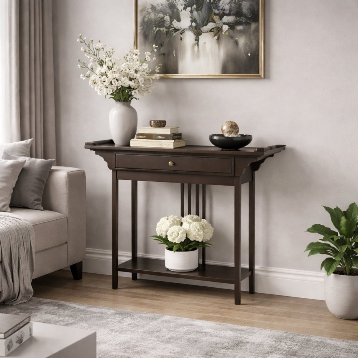 Angled view of the Kouvr Dynasty console table in a living room setting, showing the central storage drawer and the styled bottom display shelf.