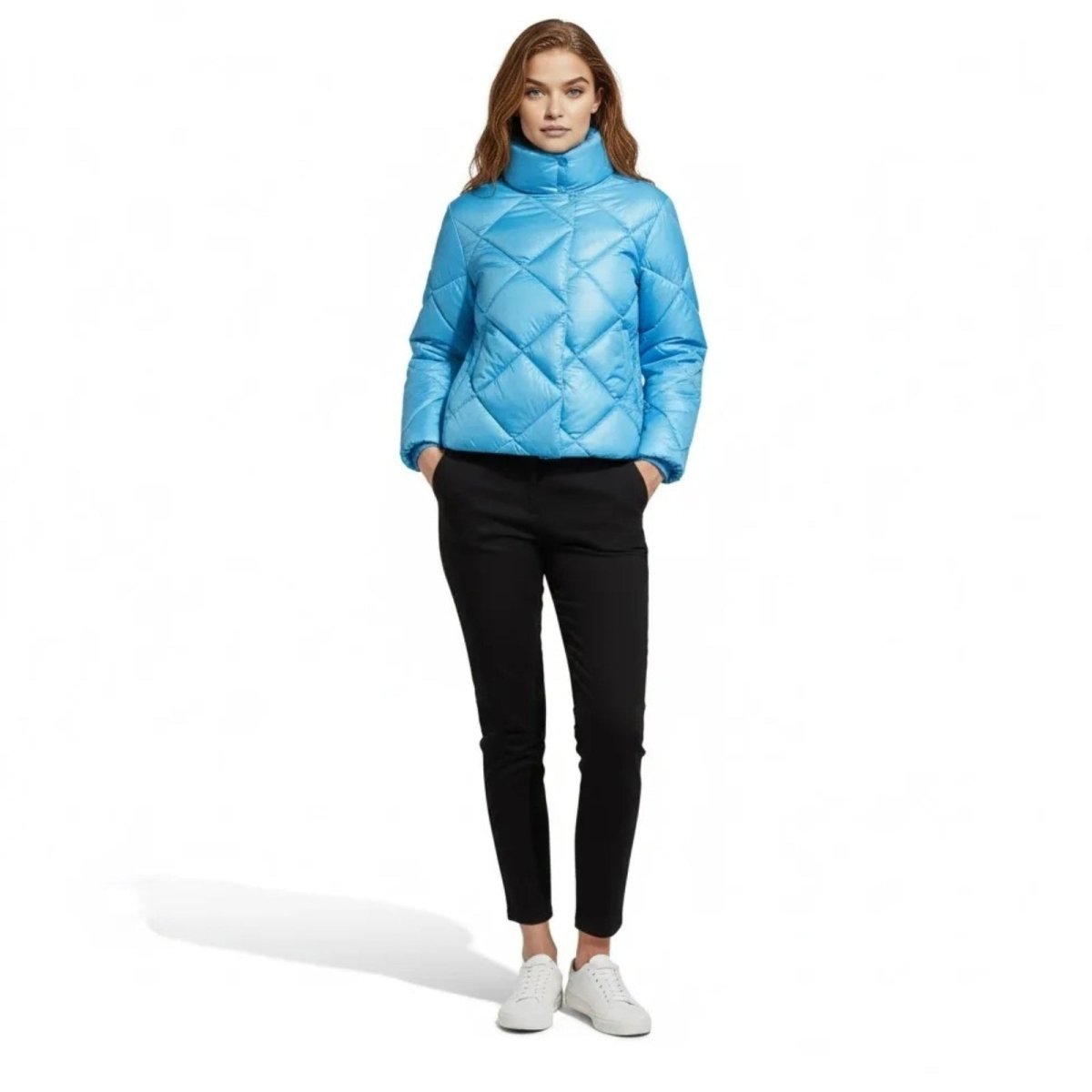 Model wearing the Kouvr Elisse sky blue diamond quilted puffer jacket with black trousers and white sneakers, front view.